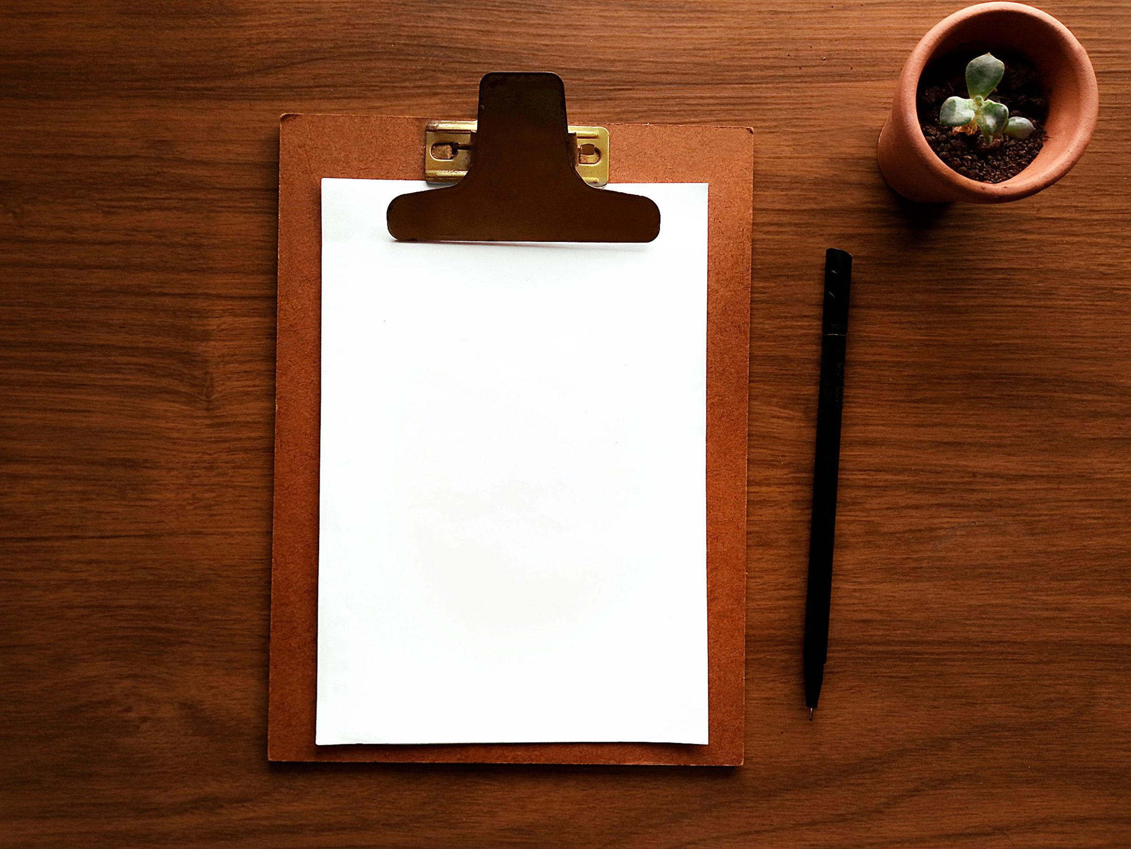 Creative strategy workspace with clipboard and desk items