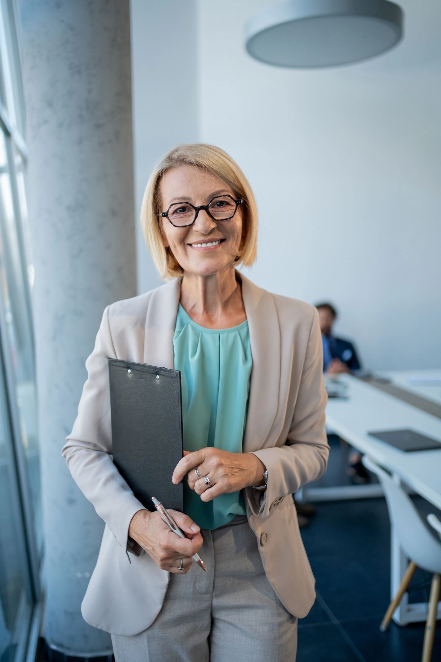Professional executive consultant standing confidently in a modern office